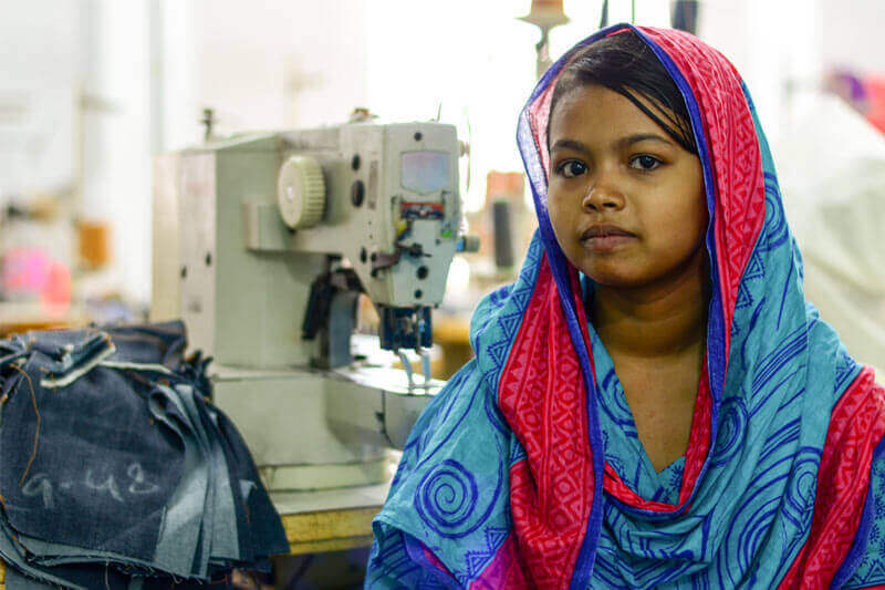 15 year old Bithi lacks child rights, and is forced to spend her days sewing jeans for high income countries