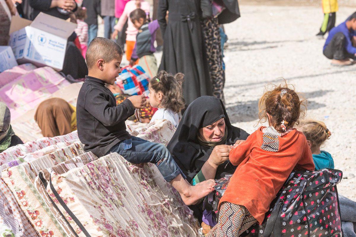 A family waits for assistance in Debaga Camp, northern Iraq.