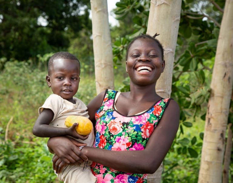 Woman holding young child on her hip
