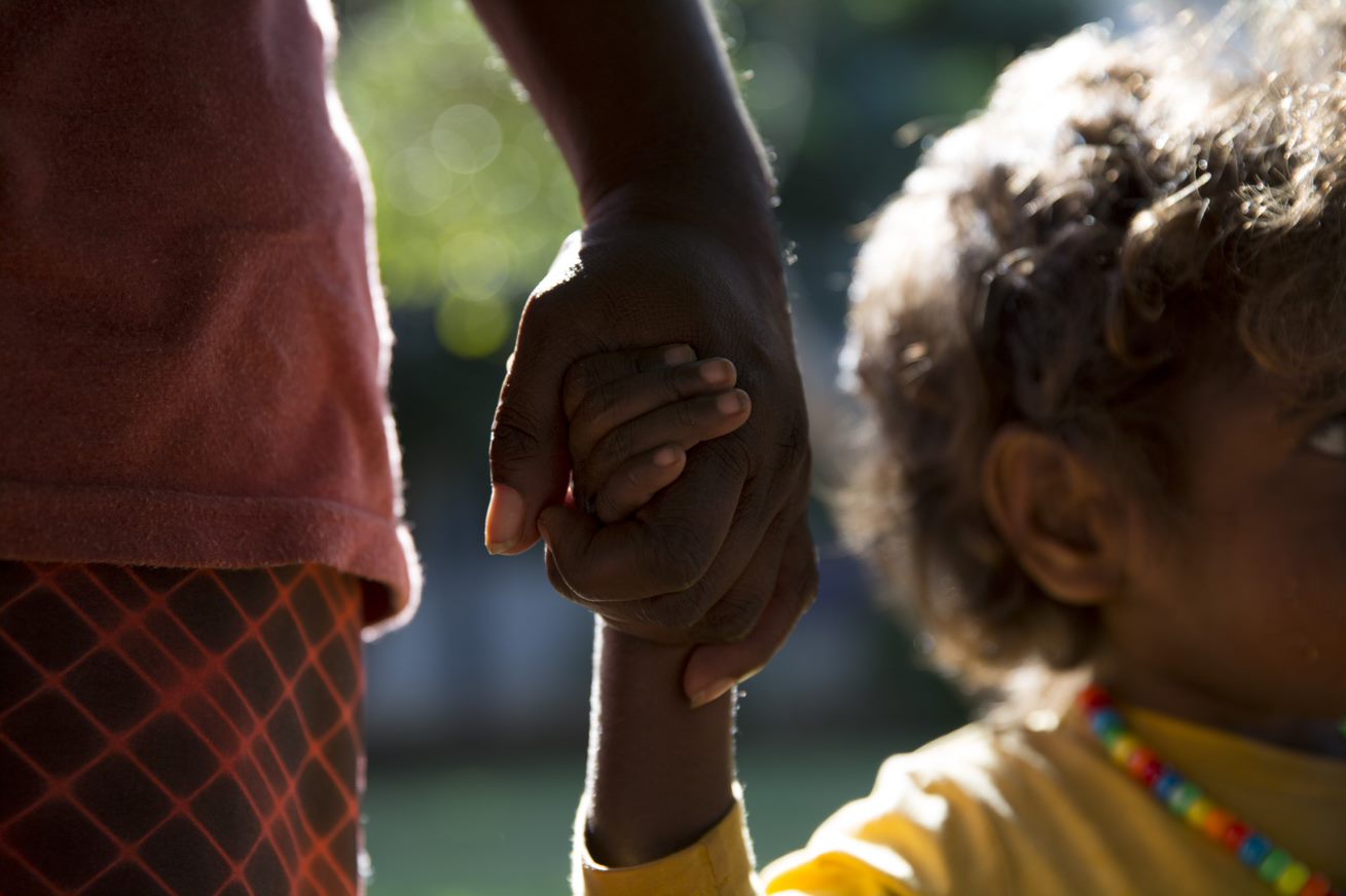 Aboriginal mother and child hold hands in the Australia Program 1