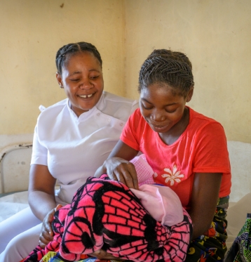 A nurse with a mother holding her baby