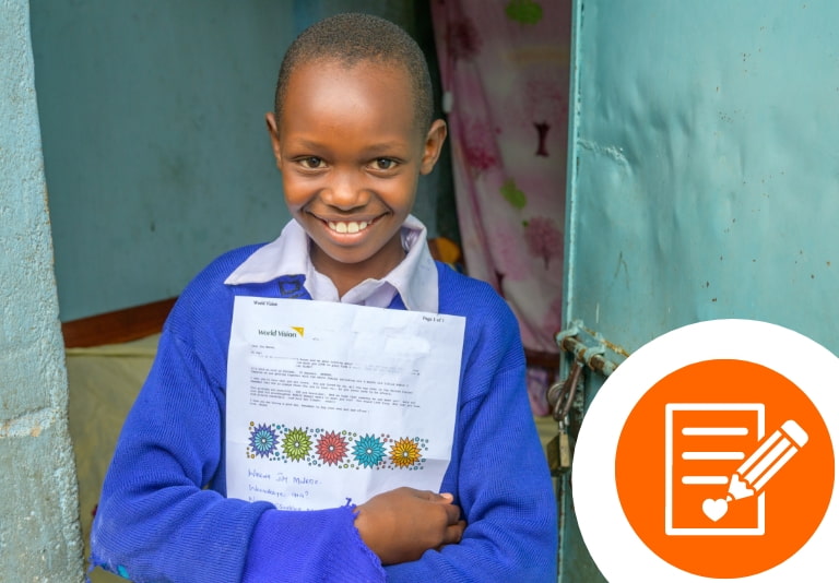 Smiling girl holding a letter from her sponsor