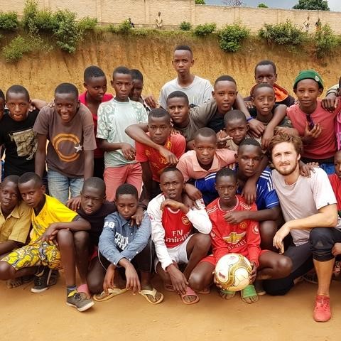 Tom Phillips with a group of Rwandan children.