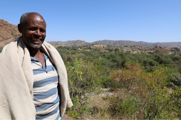 Man standing at an outlook of the valley