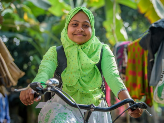 Rumana, a nutrition facilitator in southwest Bangladesh is able to ride house to house educating pregnant mothers on care for themselves and their babies, thanks to her bicycle.