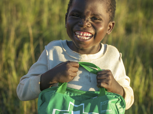 Adam, from Zambia, takes special care of his family’s first aid kit.