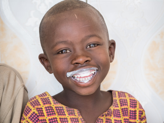 Amani drinks milk at the Tare Milk Collection Centre in Rwanda.