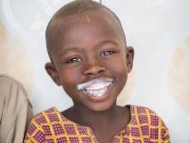 Amani drinks milk at the Tare Milk Collection Centre in Rwanda.