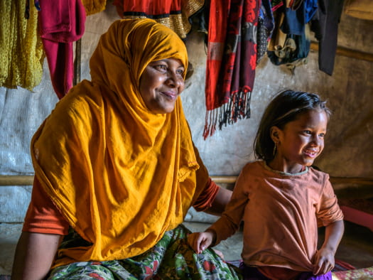 Rohingya widow Salima and her sole-surviving daughter, Jannatul take refuge and comfort in their temporary shelter in Bangladesh.