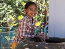Sreyani washes her hands in the clean water of her village in Banteau Meanchey province, Cambodia.