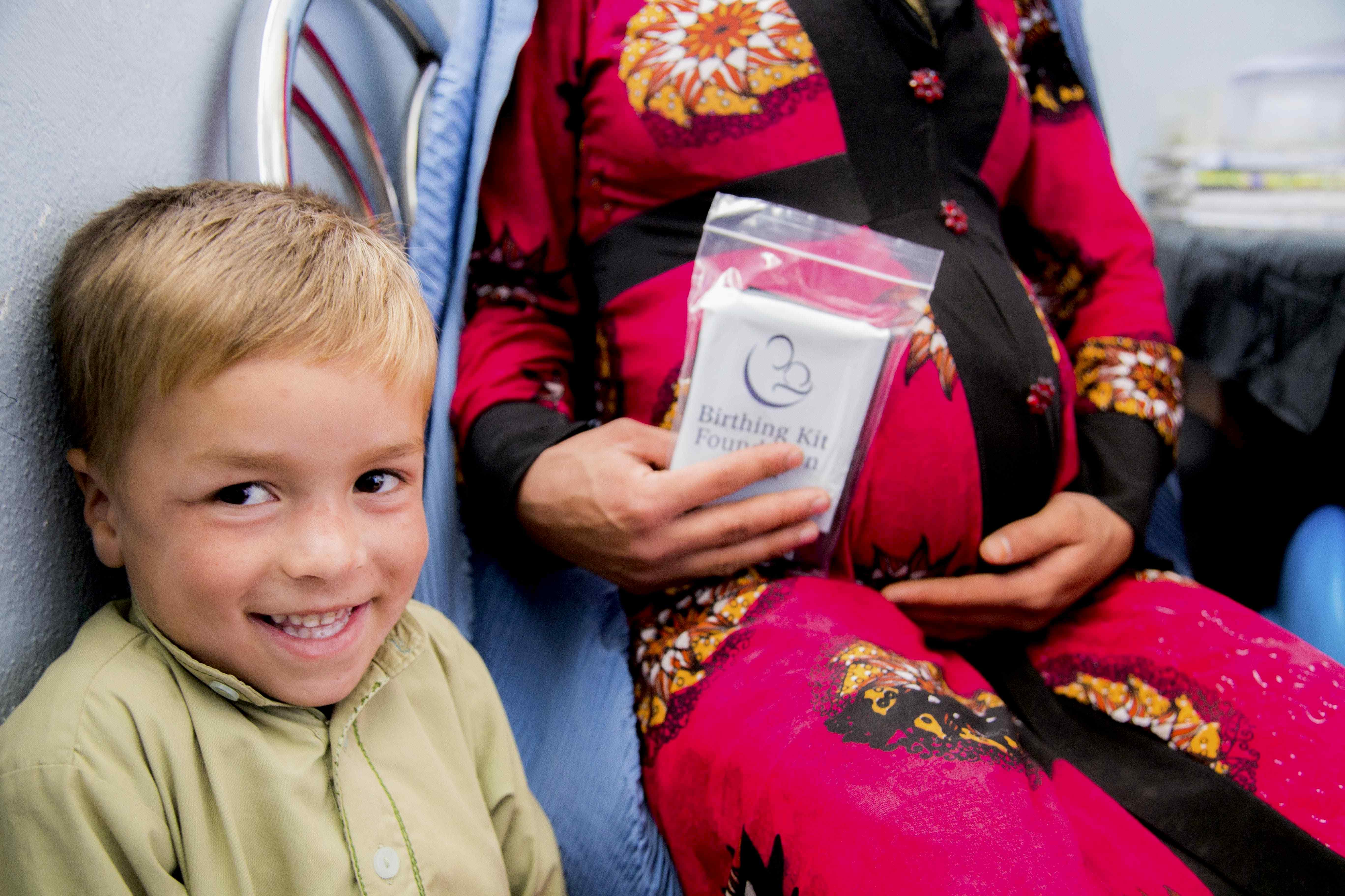Pregnant woman holding birthing kit